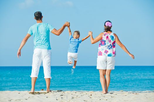 Photo of happy family having fun on the beach