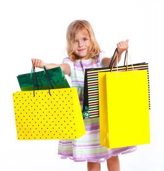 Shopping little girl happy smiling holding shopping bags isolated on white background.