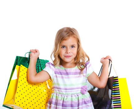 Shopping little girl happy smiling holding shopping bags isolated on white background.