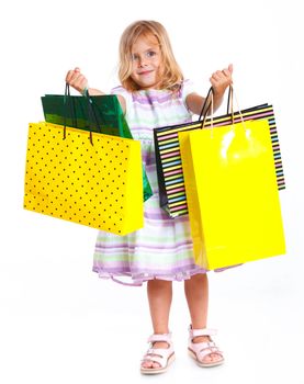 Shopping little girl happy smiling holding shopping bags isolated on white background.