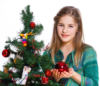 Christmas theme - Beautiful girl decorating christmas tree. Isolated on white backround.