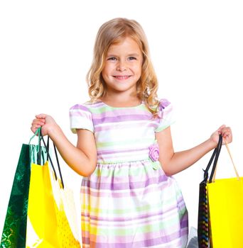 Shopping little girl happy smiling holding shopping bags isolated on white background.