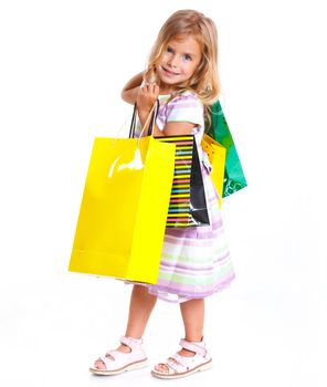 Shopping little girl happy smiling holding shopping bags isolated on white background.