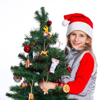 Christmas theme - Beautiful girl decorating christmas tree. Isolated on white backround.