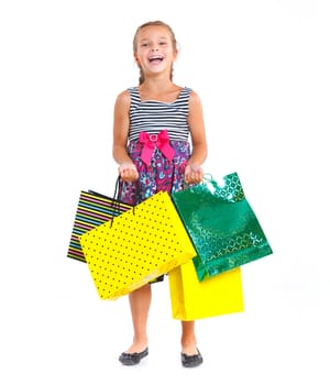 Shopping little girl happy smiling holding shopping bags isolated on white background.