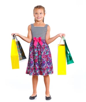 Shopping little girl happy smiling holding shopping bags isolated on white background.