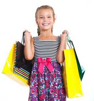 Shopping little girl happy smiling holding shopping bags isolated on white background.