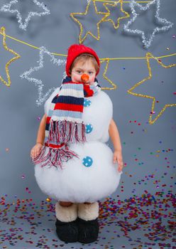 Cute little boy in suit snowman in red hat and mittens