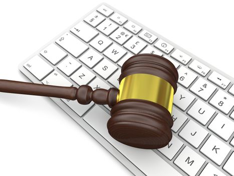 Wooden gavel on computer keyboard, symbol of law and justice in technology