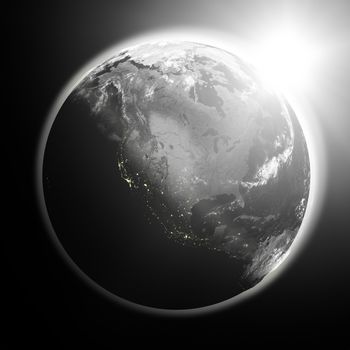 Space view of the sun rising over North America on black planet Earth. Elements of this image furnished by NASA.