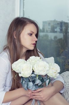 Gothic style. Woman with a rose in hands in snow-covered