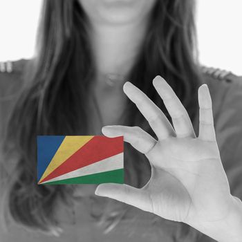 Woman in showing a business card, Seychelles