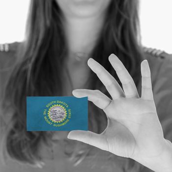 Woman showing a business card, black and white, South Dakota