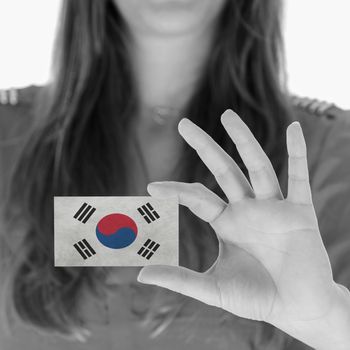 Woman showing a business card, black and white, South Korea