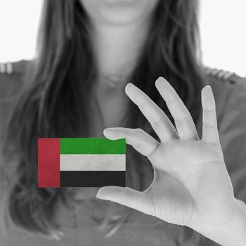 Woman showing a business card, black and white, United Arab Emirates