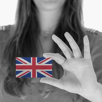 Woman showing a business card, black and white, United Kingdom