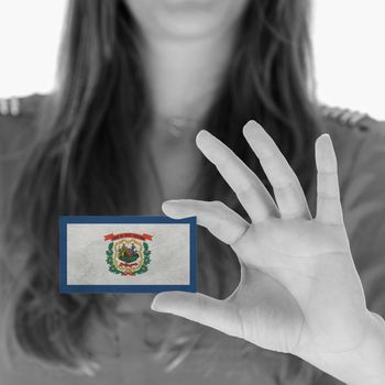 Woman showing a business card, black and white, West Virginia