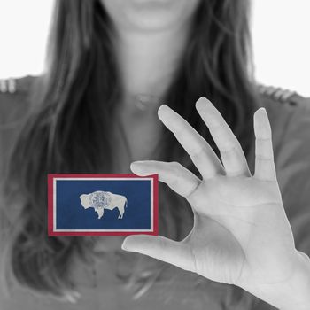 Woman showing a business card, black and white, Wyoming