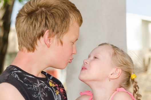 First love and kiss: two happy cute kids meeting