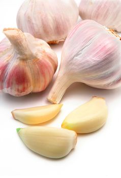 garlic cloves and buds isolated in white
