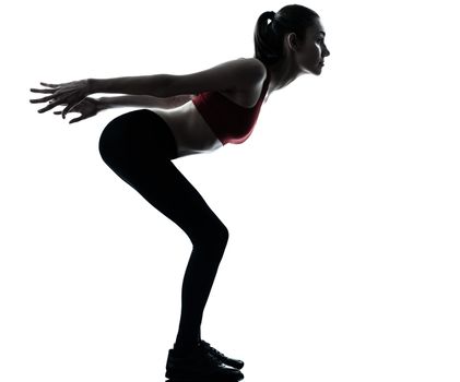 one caucasian woman exercising stretching arms in silhouette studio isolated isolated on white background