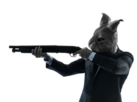 one caucasian man rabbit mask hunting with shotgun portrait in silhouette studio isolated on white background