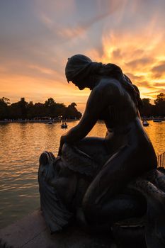 Female sculpture of Alfonso XII monument in Buen Retiro park lake, Madrid