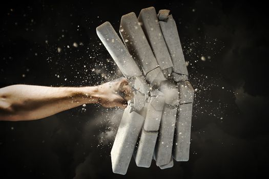 Close up of human hand breaking bricks