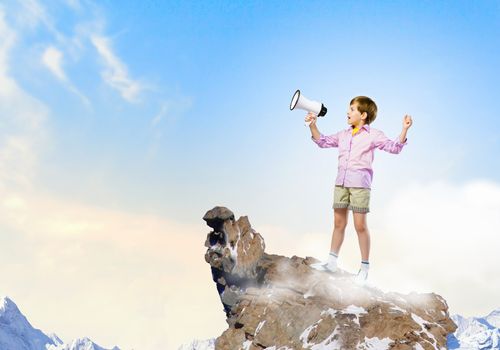 Image of little cute boy shouting in megaphone