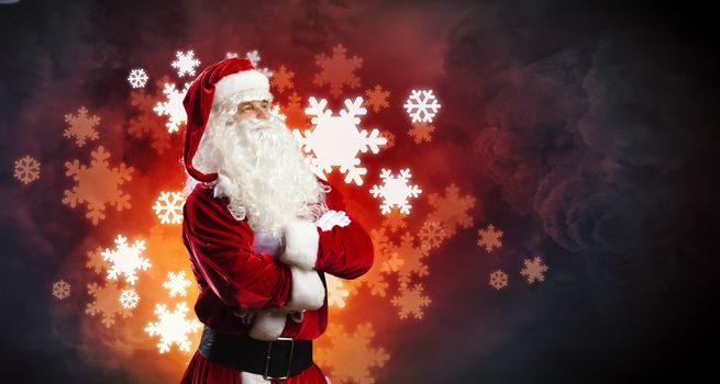 Image of Santa Claus in red costume against dark background