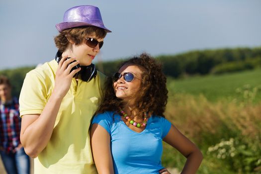 Young man and young woman outdoors. Summer vacation