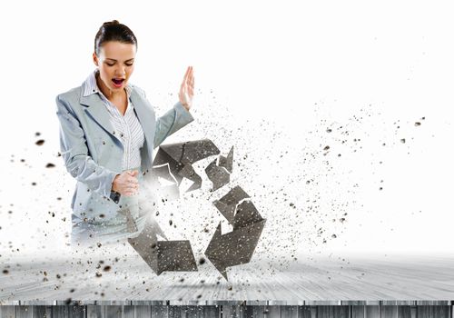 Image of businesswoman crashing recycle stone symbol