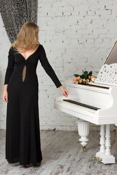 A beautiful young woman playing piano