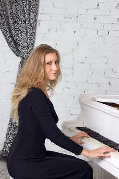 Beautiful middle eastern girl playing piano
