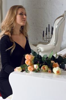 beautiful young woman playing the white piano