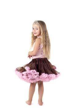 Shot of little girl with long blond hair and skirt in studio