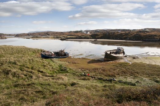 old fishing boats beached on a coastal beach in county Donegal, Ireland