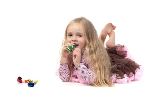 Shot of little girl with long blond hair lying in studio