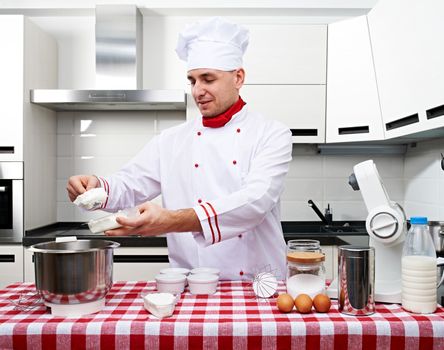 Male chef at kitchen getting ready to cook