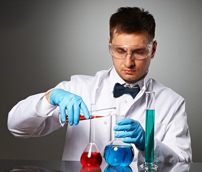 Scientist in protective glasses at laboratory