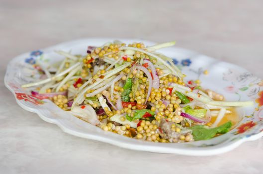 close up spicy Salad made with horseshoe crab eggs   and  mix vegetable on dish