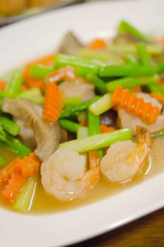  stir fried  prawn  with mix vegetable and sauce  on white dish