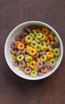 Shot of multicolored corn flakes (rings) on the plate