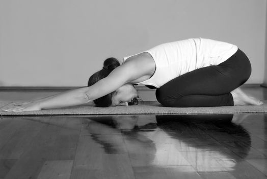 Girl doing Sasankasana yoga pose