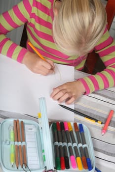 young child writting , painting and playing with colours (chinese child)