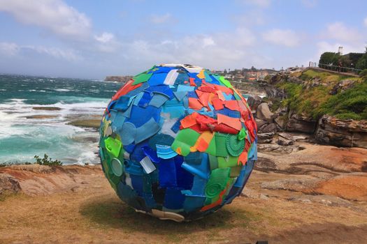 BONDI BEACH, AUSTRALIA - OCTOBER 29, 2013: Sculpture By The Sea, Bondi 2013. Annual event that showcases artists from around the world  Sculpture titled 'Plastic World' by Carole Pumelle and Nuno Maya (Portugal).  Medium iron and plastic
