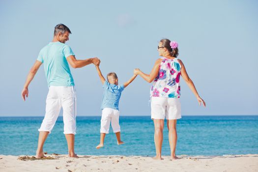 Photo of happy family having fun on the beach