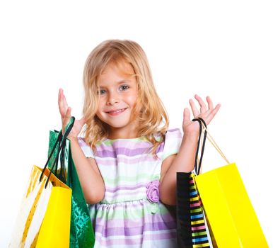 Shopping little girl happy smiling holding shopping bags isolated on white background.