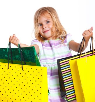 Shopping little girl happy smiling holding shopping bags isolated on white background.