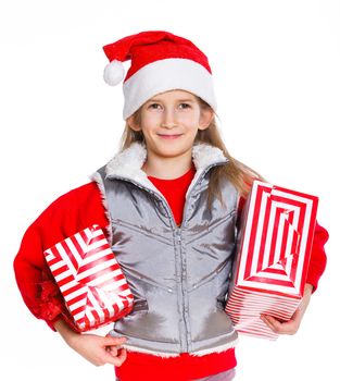 Christmas theme - Smiling cute girl in Santa's hat with gift box, isolated on white